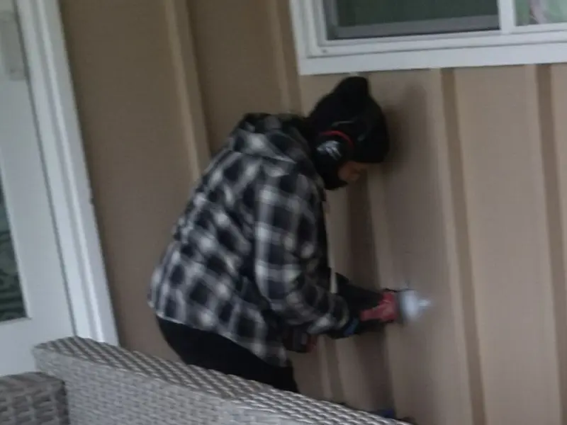 Professional electrician installing an exterior outlet in Gentry