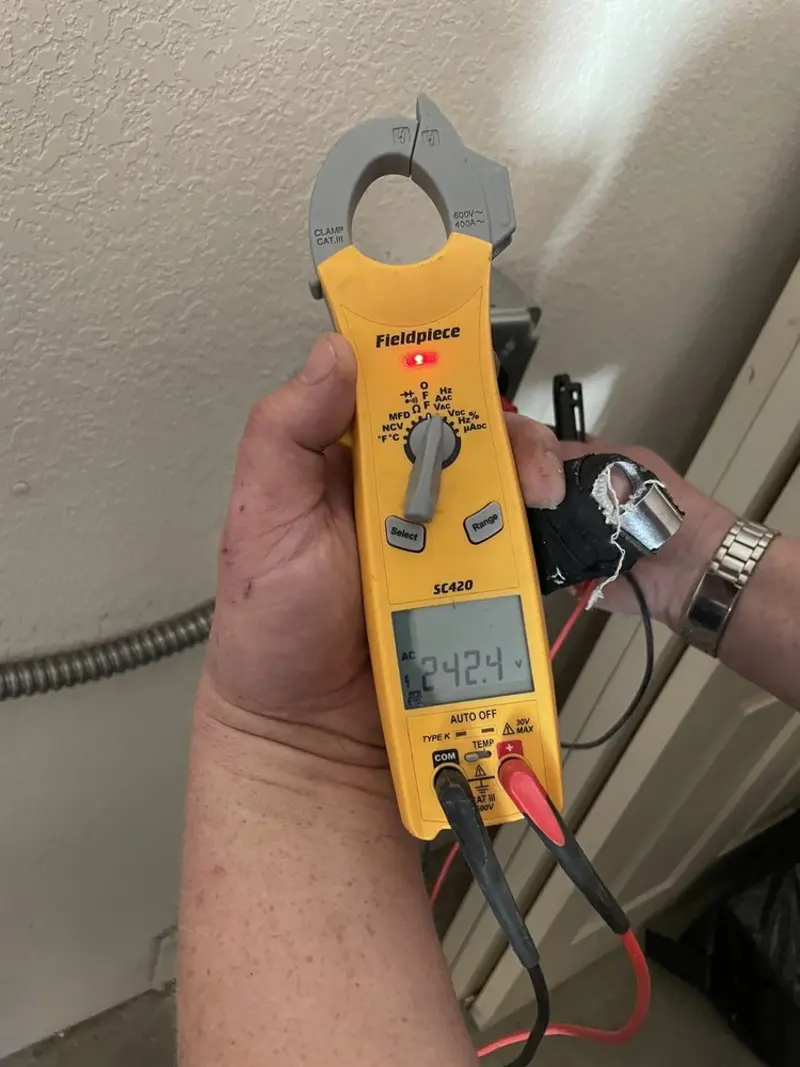 Voltage testing with clamp meter during Electrical Installation Services in Gentry